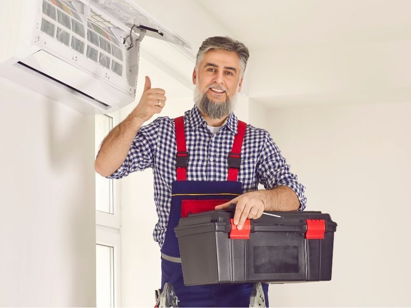 Man after performing maintenane on air conditioning unit