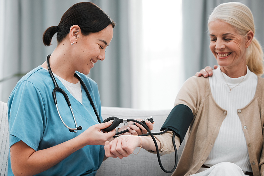 Nurse, doctor or old woman with blood pressure test consulting in hospital to monitor heart wellness. Healthcare, hypertension consultation or medical physician with a happy patient for examination. 