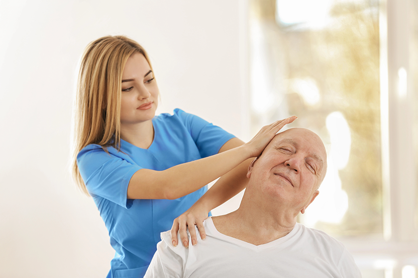 Physiotherapist working with elderly patient in clinic